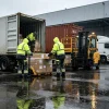 Leapy hi vis workwear solution for Warsaw logistics workers loading cartons in rainy warehouse conditions