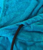 Close-up of the black hood drawstring on a turquoise Leapy absorbent changing robe