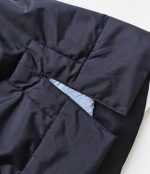 Close-up of the navy Leapy waterproof changing robe hem opening with grey Sherpa lining