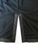 Close-up of the split hem and textured black lining on a Leapy water-repellent changing robe