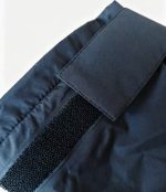 Close-up of the hook-and-loop adjustable cuff on a navy Leapy windproof changing robe