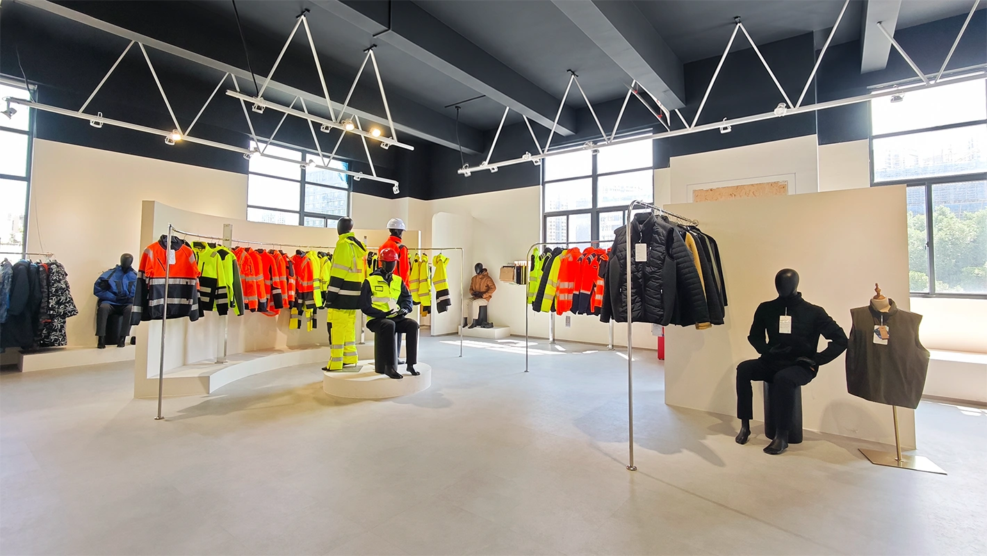 LEAPY workwear factory showroom displaying high-visibility reflective jackets, safety vests, and OEM clothing lines.
