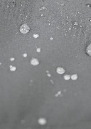 Water droplets beading on LEAPY DWR coated waterproof membrane fabric surface for workwear protection.
